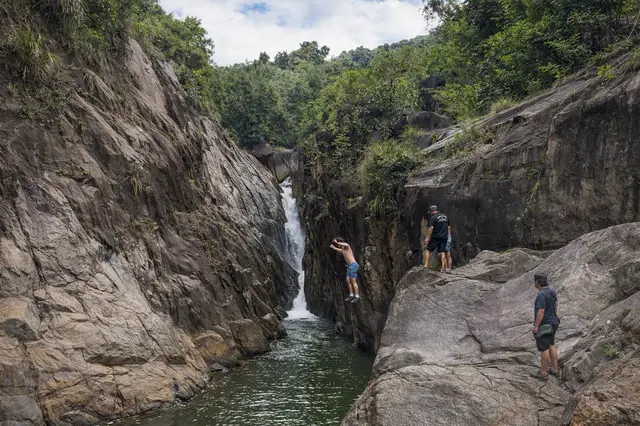 Guest cliff jumping into the deep gorge pool at Charco El Hippie on the Adventure Expedition