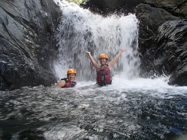 Swimming in natural pool beneath El Yunque waterfall
