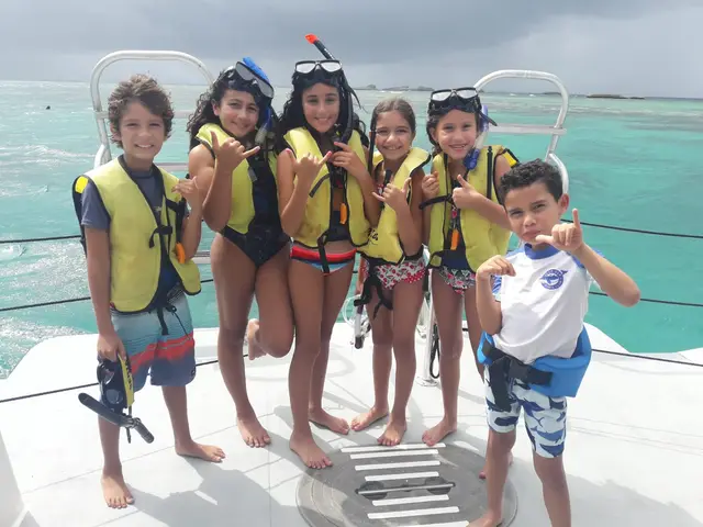 Kids celebrating on the boat deck with turquoise water behind them