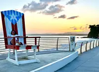 Guest in the Puerto Rican flag chair at Malecón de Naguabo sunset